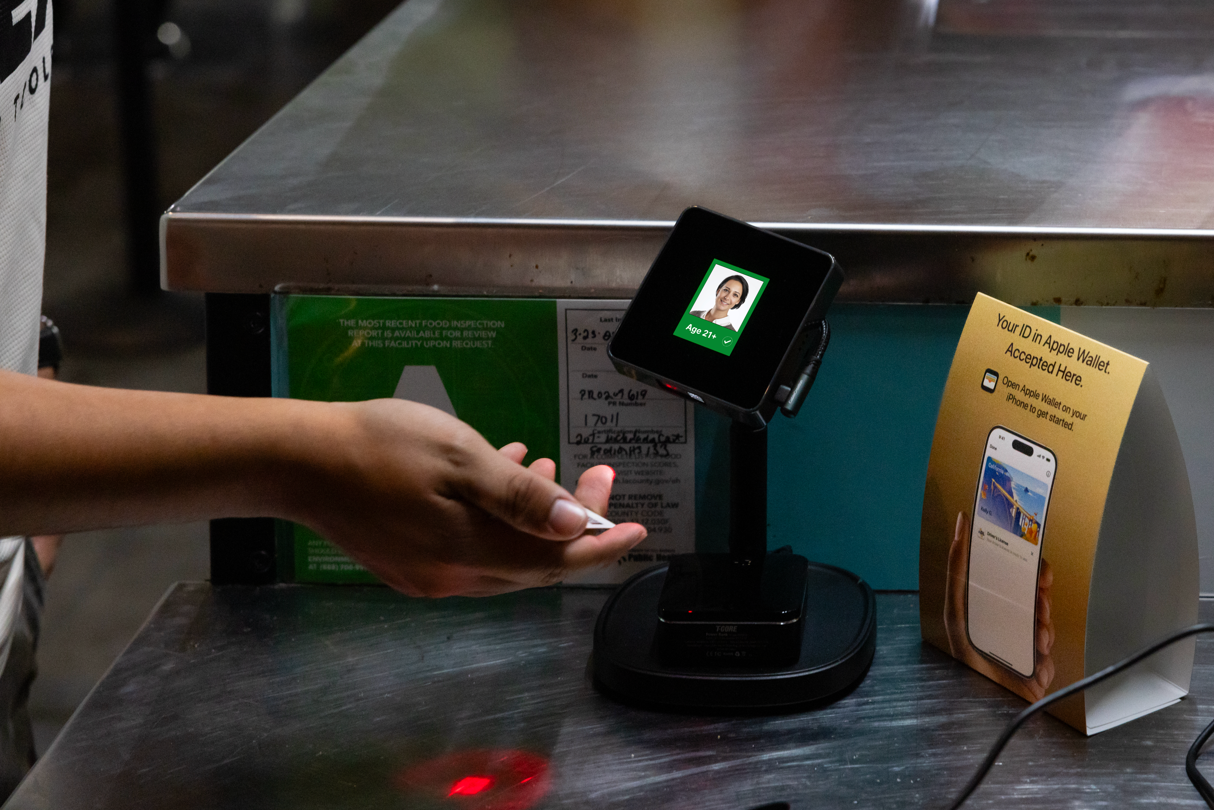 Physical ID being scanned by Tap2iD Verifier showing Age 21+ verification