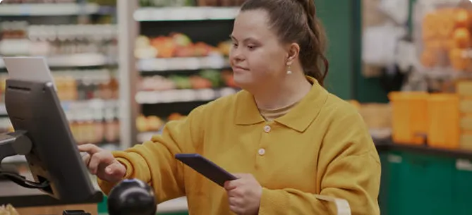 Budtender verifying a customer's mobile driver's license (mDL) at a dispensary checkout